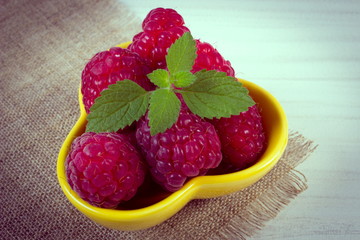 Vintage photo, Fresh raspberries and lemon balm on white wooden table, healthy food