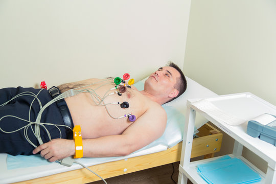 Male patient having ECG electrocardiogram in hospital