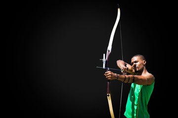 Facing view of man practicing archery against white background