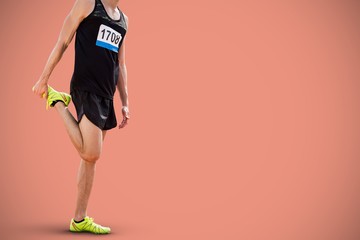 Fototapeta na wymiar Composite image of sporty man stretching his leg