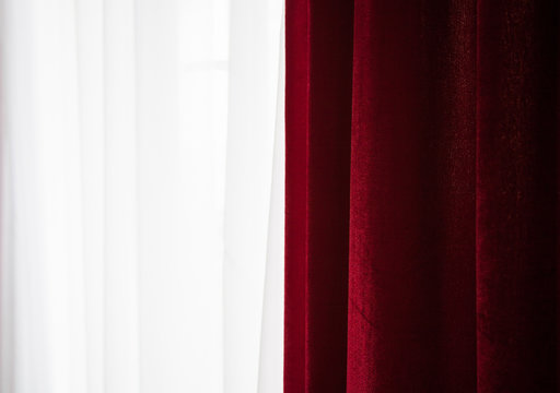 Fragment of the window with red curtein