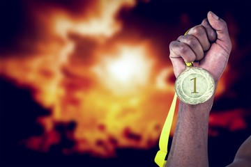 Fototapeta na wymiar Composite image of athlete holding gold medal after victory