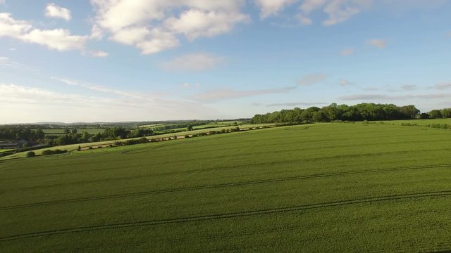  Aerial flight above forest & fields in the English countryside