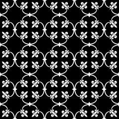 Forged seamless pattern of white fleur-de-lis on a black background. Openwork metal fence design. Modern style for wallpaper, wrapping, fabric, background, apparel, other print production. Vector © alona_s