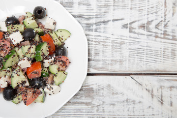 Fresh salad with black quinoa, tomatoes, cucumbers and feta chee