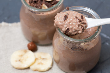 Chocolate pudding with chia seed, bananas and nuts,  in a glass