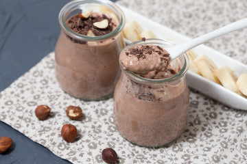 Chocolate pudding with chia seed, bananas and nuts,  in a glass