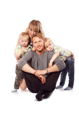 Caucasian happy smiling young family with two children sitting o
