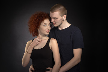 Portrait of young couple in love posing at studio