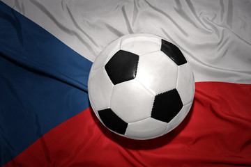 Naklejka premium black and white football ball on the national flag of czech republic