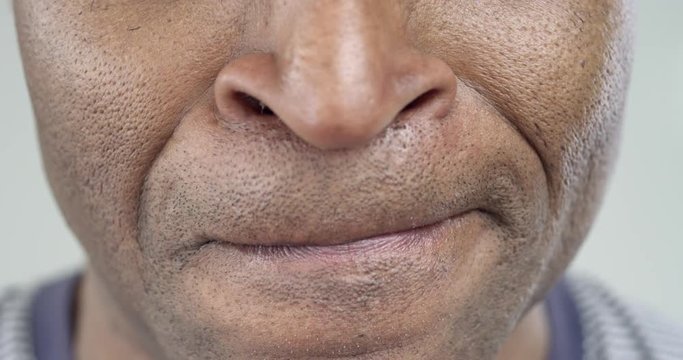 The Man Strongly Displeased/Male African-American strongly angry. His lips pressed tightly together