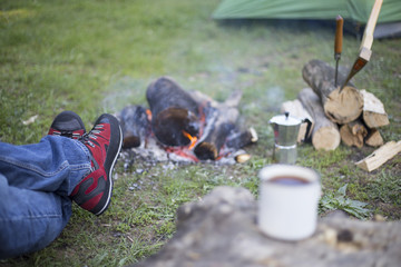 Man drinking coffee by the fire.
