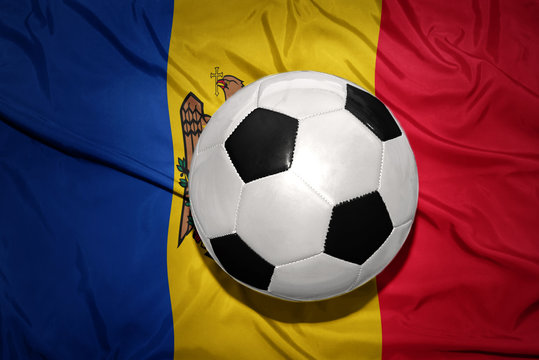 black and white football ball on the national flag of moldova