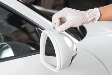 Car detailing series : Closeup of hand  coating white car paint