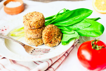 lentil cutlets with paprika and porridge, greens, tomato, vegan
