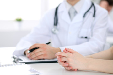 Doctor and patient are discussing something, just hands at the table