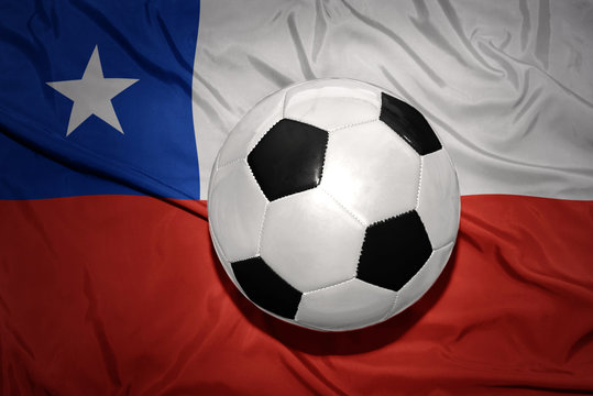 black and white football ball on the national flag of chile