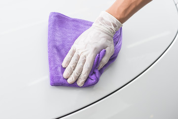 Car detailing series : Closeup of hand cleaning white car