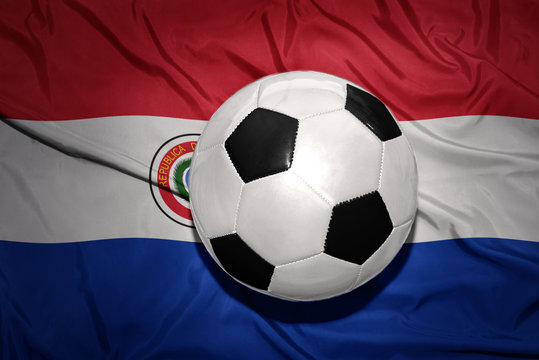 black and white football ball on the national flag of paraguay