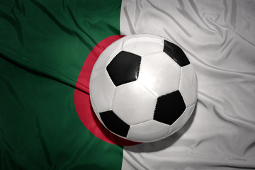 Fototapeta premium black and white football ball on the national flag of algeria