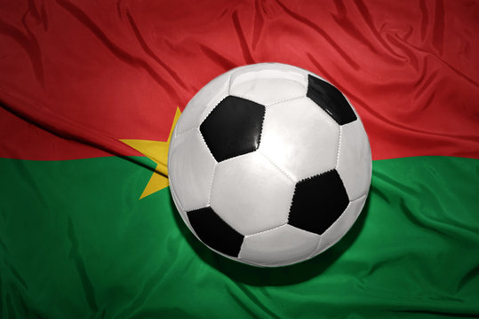 black and white football ball on the national flag of burkina faso