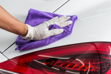 Car detailing series : Closeup of hand cleaning white car