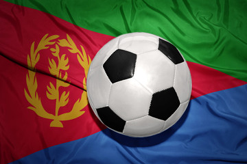 Fototapeta premium black and white football ball on the national flag of eritrea