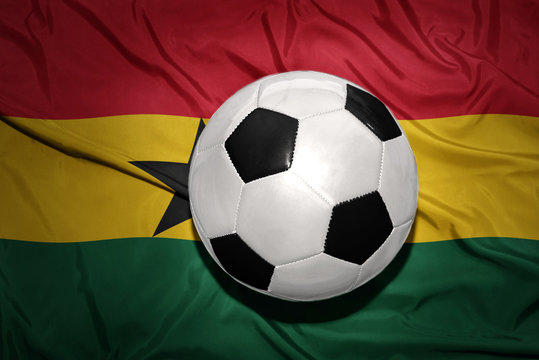 black and white football ball on the national flag of ghana