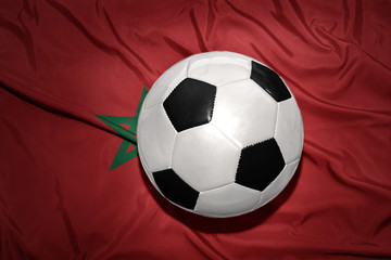 black and white football ball on the national flag of morocco