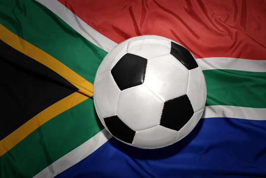black and white football ball on the national flag of south africa