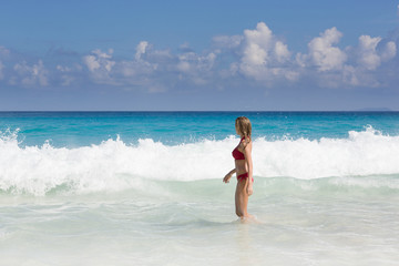 Fototapeta na wymiar Beautiful and sexy blonde woman in red bikini, turquise sea