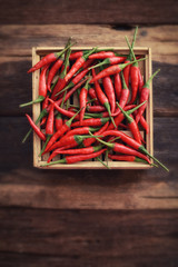 Red Hot Chili Peppers in wooden box on old wooden background, 