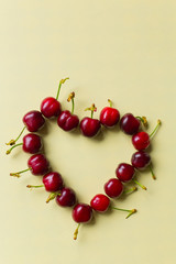 heart of cherries on clear background, minimal spring theme