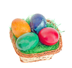 Colored romanian traditional Easter eggs in a basket with green grass, bunny, isolated