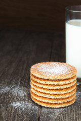 Waffles with milk on dark rustic wood
