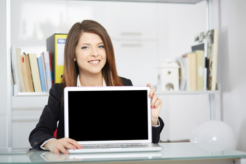 young businesswoman showing blank screen