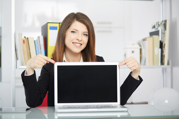 young businesswoman showing blank screen