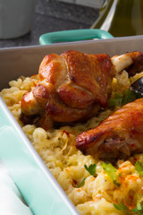 Baked spicy wings of turkey with cheese noodles.