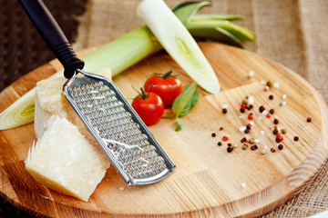 Beautiful Parmesan cheese with leek and spices on the kitchen Board