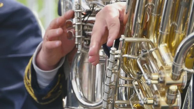 Musicians playing on the golden tubas