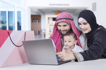 Family shopping online with laptop