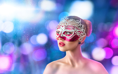 Beautiful young woman in venetian carnival mask