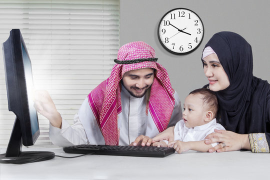 Happy Middle Eastern Family Shopping Online