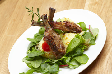 grilled ribs with leaves of green lettuce