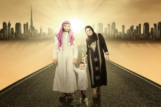 Middle eastern family walking on the road