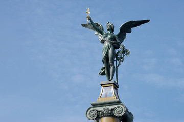 Angel on top of a column on the Cechuv Most Bridge in Prague © philipbird123