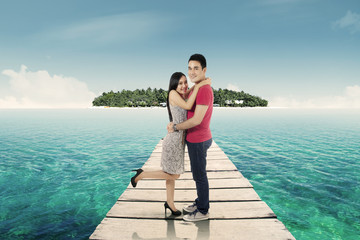 Young couple on the wooden jetty