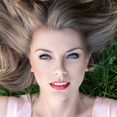 Young girl lying on a grass