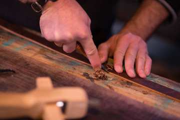 Leather goods craftsman at work in his workshop