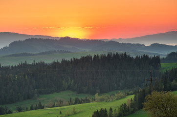 Moments before sunrise in misty Carpathian mountains, spring, Poland